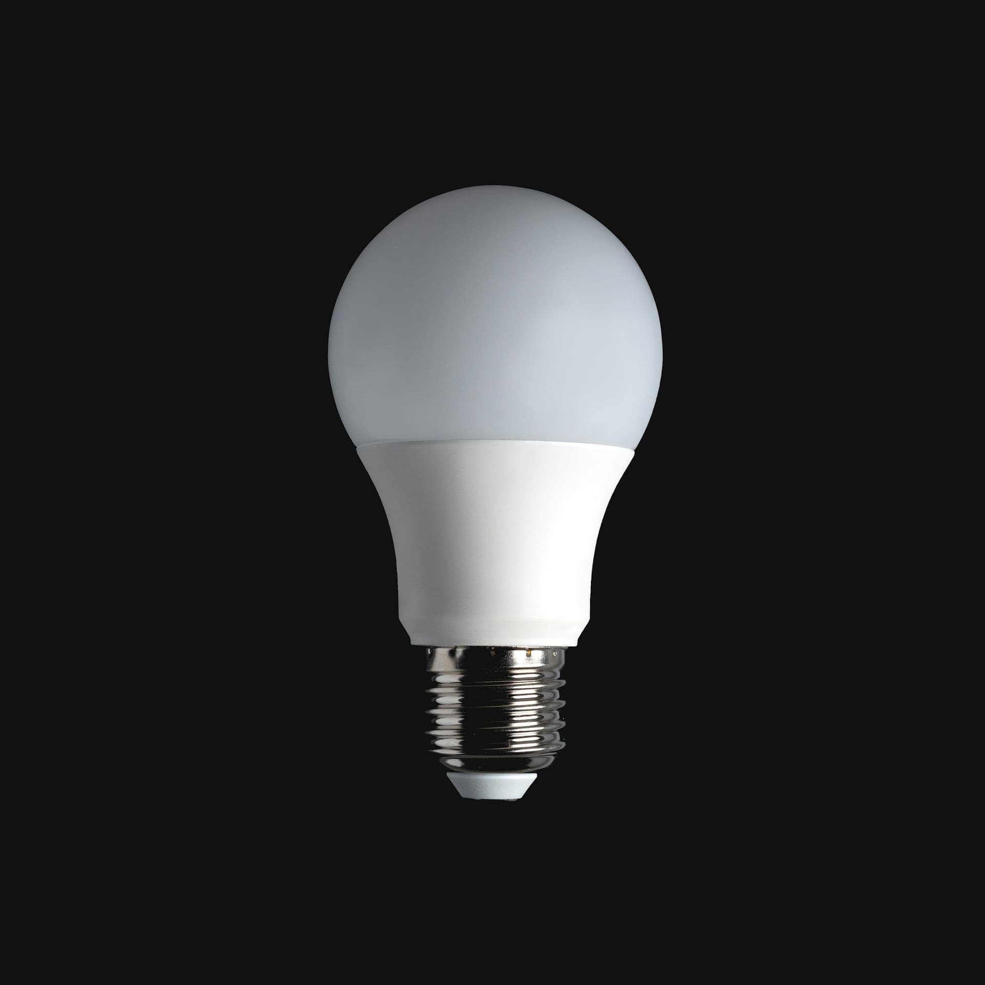 A single white LED light bulb against a plain black background