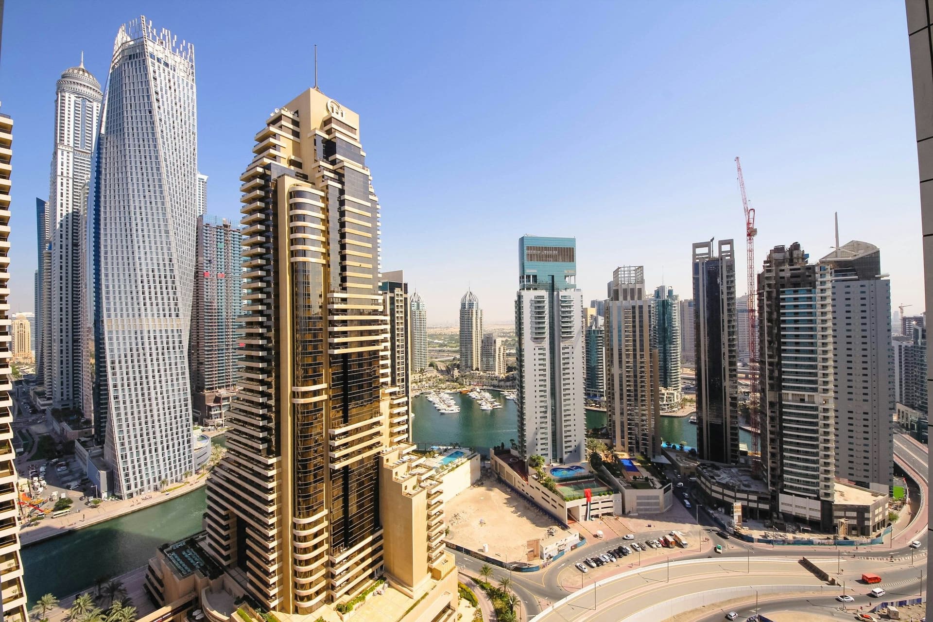 Dubai Marina towers and waterways seen from a high viewpoint under a clear blue sky