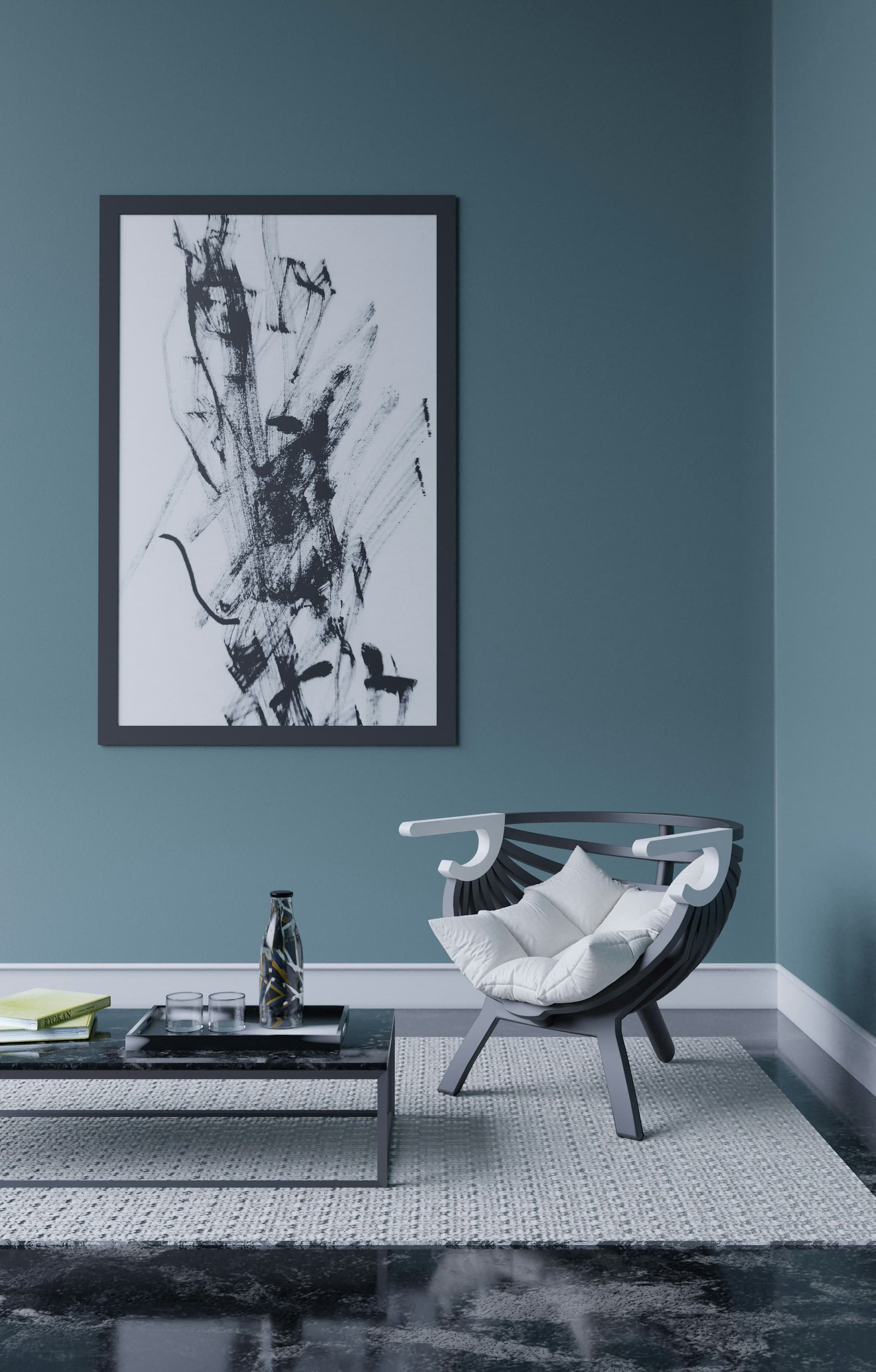Deep blue-gray painted wall with a framed abstract print above an armchair and a low table