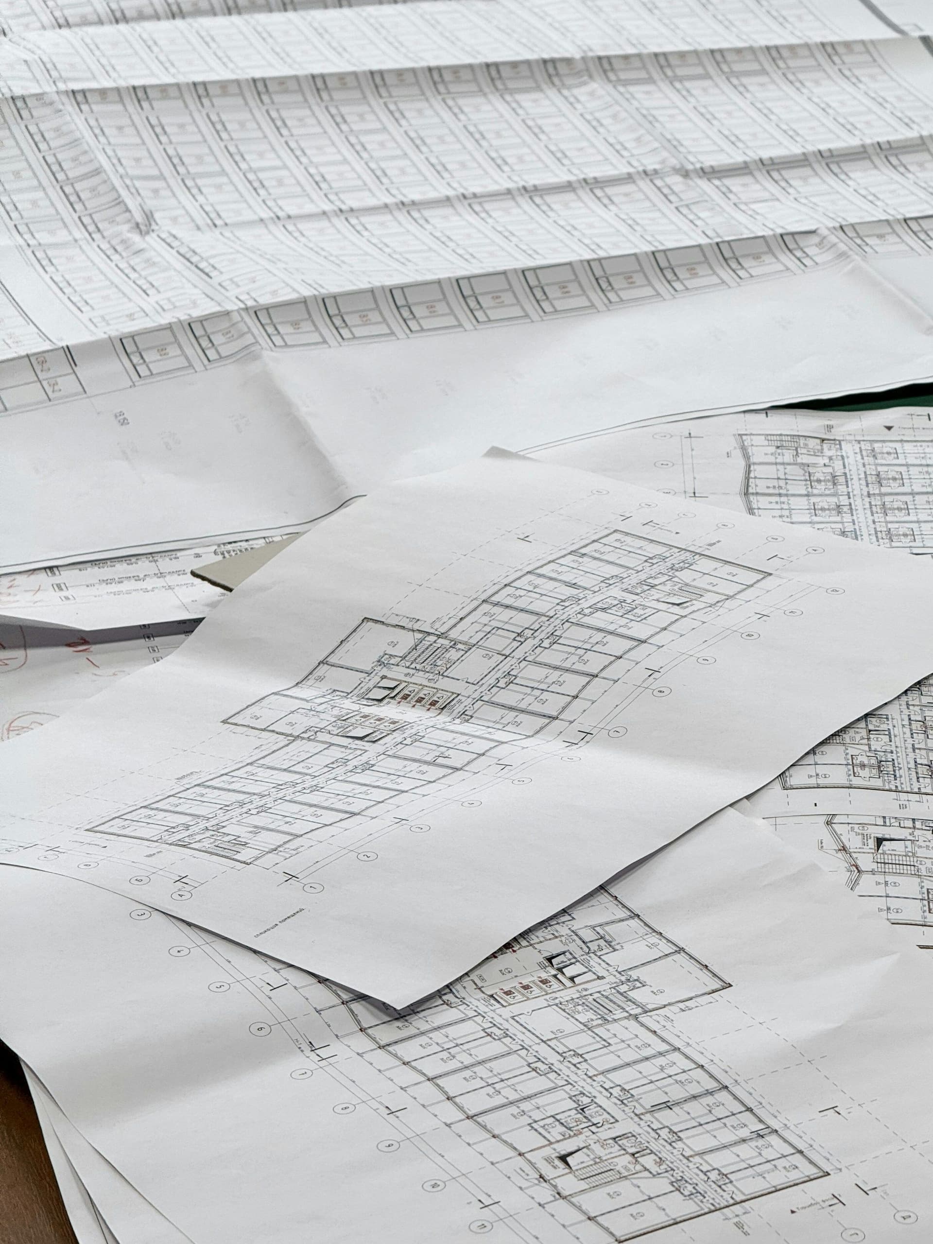 Floor plan drawings spread out on a table